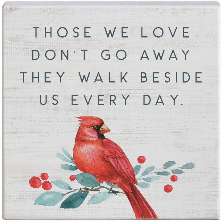 Decorative sign with a red cardinal bird and inspirational message  those we love don't go away they walk beside us every day.