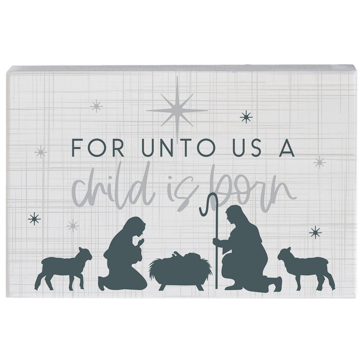 Decorative wooden sign with nativity scene silhouette and text 'For unto us a child is born' on a white background.